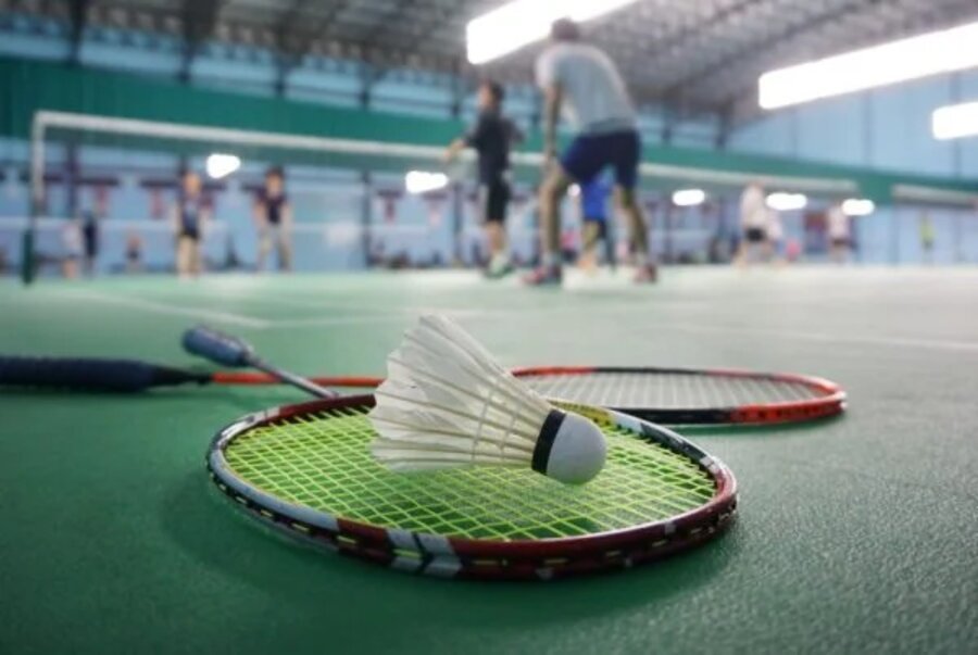 Badminton rackets and shuttlecock on court
